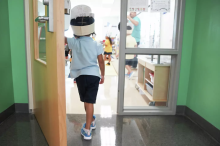 A child enters a classroom. Elizabeth Conley/Staff photographer