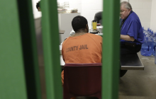 A man takes part in a therapy session in an acute unit of the mental heath unit at the Harris County jail, photo via Houston Public Media/AP Photo/Eric Gay