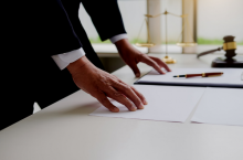 Man in suit with hands on table